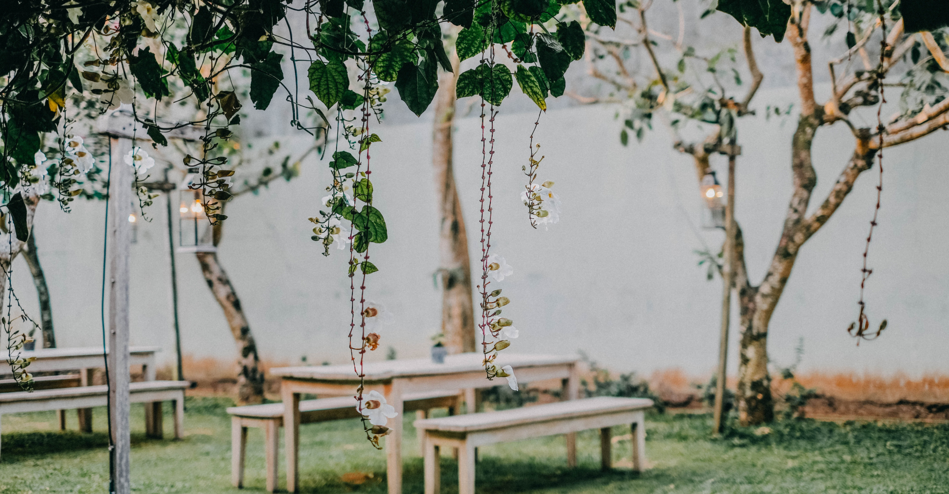 Outdoor garden swing with white flowers and greenery creating a tranquil space for relaxation and nature enjoyment