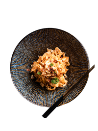 Textured black bowl, savory Japanese noodle dish, wooden chopsticks. | Texturerad svart skål, hjärtligt japanskt nudelrät, träpinnar.