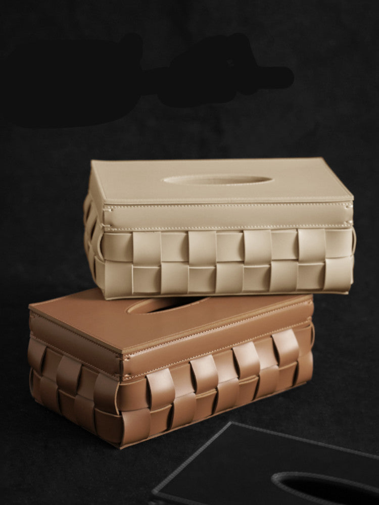 Leather tissue box collection, brown and cream stacked. | Samling av lädernäsduksaskar, bruna och krämiga staplade.